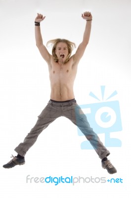 Shirtless Man Jumping High In Joy Stock Photo