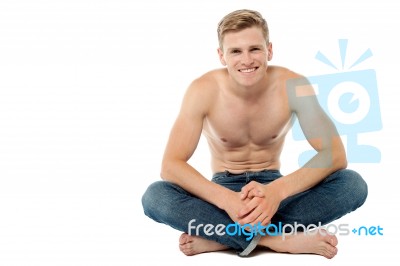 Shirtless Man Sitting On The Floor Stock Photo