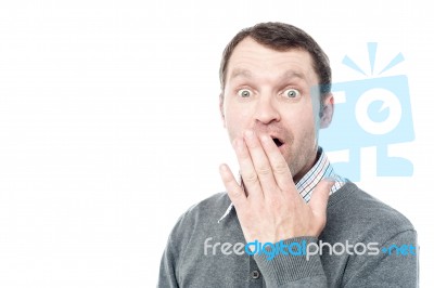 Shocked Man Covering His Mouth With Hand Stock Photo