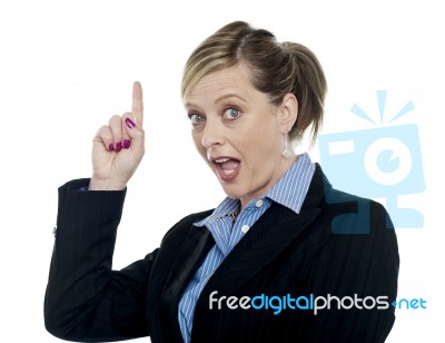 Shocking Corporate Woman Pointing Upwards Stock Photo