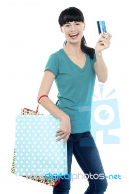 Shopaholic Woman Holding Her Cash Card Up Stock Photo