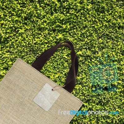 Shopping Bag On Green Leaves Stock Photo