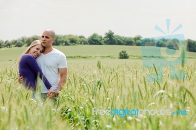 Shot Of Young Couple Hugging And Holding Hands Stock Photo