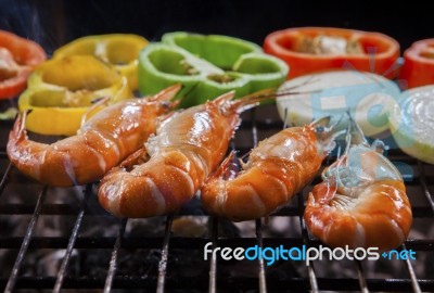 Shrimp Grilled On Barbecue Stove With Chilly And Onion Ring Stock Photo