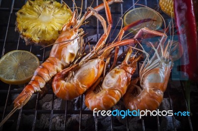 Shrimp Grilled On Barbeque Charcoal Oven With Lemon Pineapple Red Chilly And Corn Stock Photo