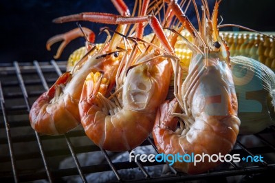 Shrimp ,prawns Grilled On Barbecue Stove With Corn Behind Stock Photo