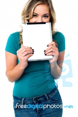 Shy Pretty Model Hiding Face With Tablet Pc Stock Photo