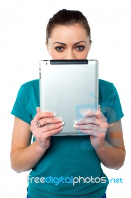 Shy Pretty Model Hiding Face With Tablet Pc Stock Photo