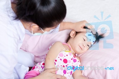 Sick Little Girl Nursed By A Pediatrician Stock Photo