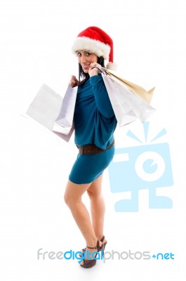 Side Pose Of Christmas Woman Holding Bags On White Background Stock Photo