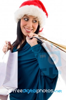 Side Pose Of Christmas Woman Holding Bags On White Background Stock Photo