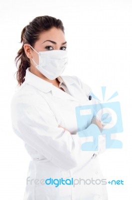 Side Pose Of Doctor With Mask And Folded Hands Stock Photo