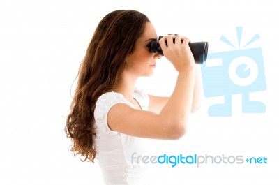 Side Pose Of Female Holding Binocular Stock Photo