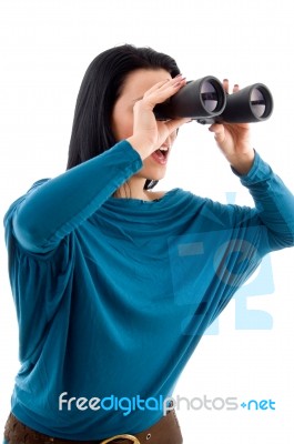 Side Pose Of Female Looking Through Binocular On White Background Stock Photo