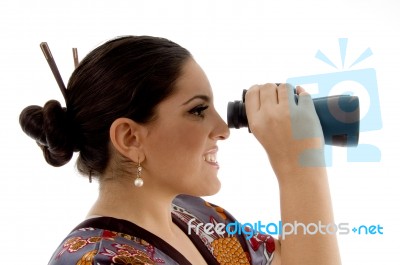 Side Pose Of Female Watching Through Binocular Stock Photo