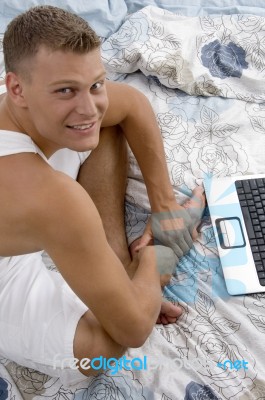 Side Pose Of Male With Notebook Stock Photo