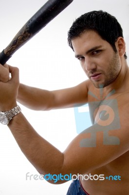 Side Pose Of Man With Stick Stock Photo