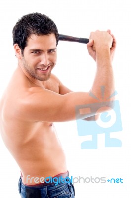 Side Pose Of Smiling Man With Stick Stock Photo