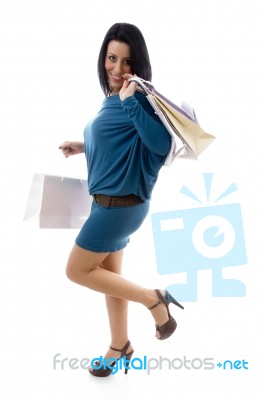 Side Pose Of Smiling Model Holding Carry Bags Stock Photo