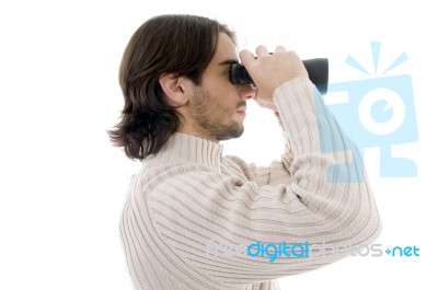 Side Pose Of Young Man Watching Through Binocular Stock Photo