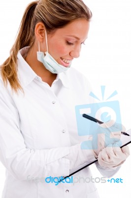 Side View Of Doctor With Writing Pad Stock Photo