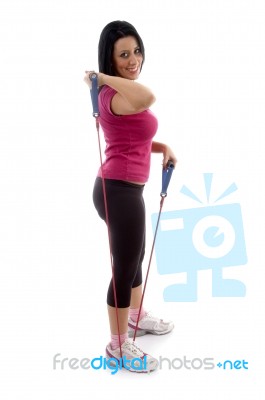 Side View Of Exercising Female Looking At Camera Stock Photo