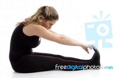 Side View Of Female Doing Exercise Stock Photo