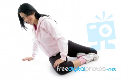 Side View Of Female Doing Exercise On White Background Stock Photo