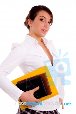 Side View Of Female Student Holding Books Stock Photo