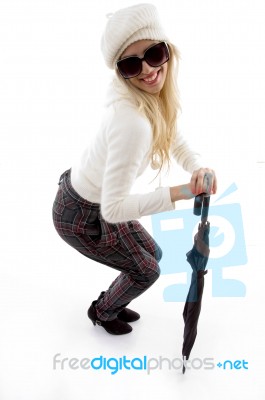 Side View Of Happy Female Holding An Umbrella Stock Photo