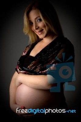 Side View Of Happy Pregnant Female Stock Photo