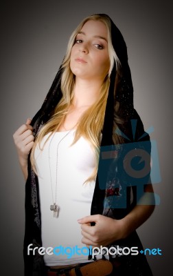 Side View Of Young Female Wearing Stole And Looking At Camera Stock Photo