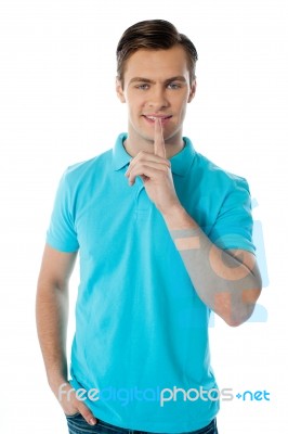 Silence Gesture By A Young Guy Stock Photo