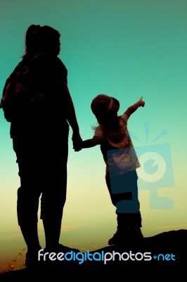 Silhouette Back View Of Mother And Daughter Clasping Hand Togeth… Stock Photo