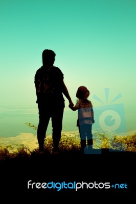 Silhouette Back View Of Mother And Daughter Clasping Hand Togeth… Stock Photo