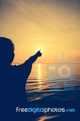 Silhouette Back View Of Woman Relax At Seaside And Pointing To T… Stock Photo