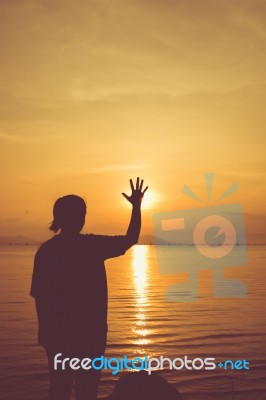 Silhouette Back View Of Woman Relax At Seaside And Showing Stop Stock Photo