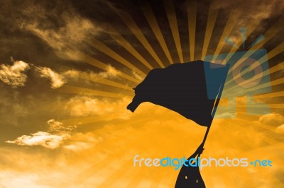 Silhouette Man Holding Flag Stock Image