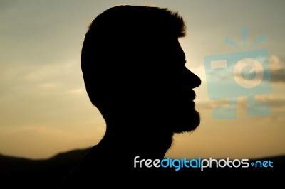 Silhouette Of A Man In The Sunset Stock Photo