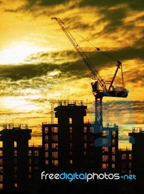 Silhouette Of Crane And Building Construction And Sun Set Sky Wi… Stock Photo