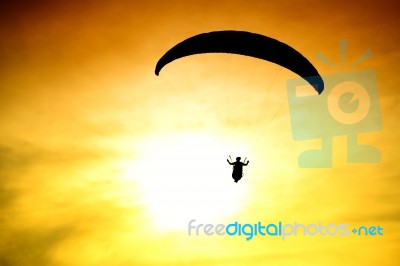 Silhouette Of Parachute On Sunset Stock Photo