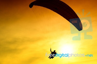 Silhouette Of Parachute On Sunset Stock Photo