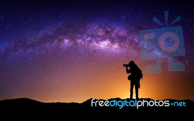 Silhouette Of Photographer With Camera And Milky Way Blackground… Stock Photo