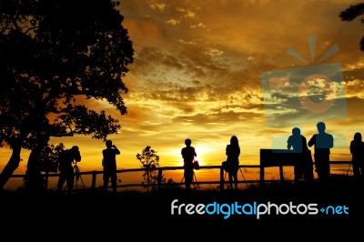 Silhouette Of Photographers Stock Photo