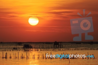 Silhouette Of Thai Fishing House At Sunset Stock Photo