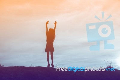 Silhouette Of Woman Praying Over Beautiful Sky Background Stock Photo