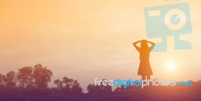 Silhouette Of Woman Praying Over Beautiful Sky Background Stock Photo