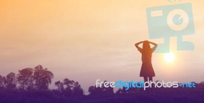 Silhouette Of Woman Praying Over Beautiful Sky Background Stock Photo