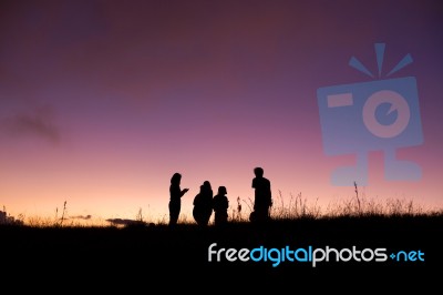 Silhouette People On Top Of Mountain Stock Photo