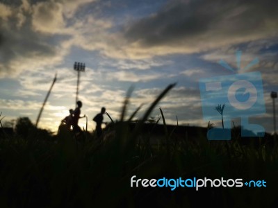 Silhouette  Running On Road At Sunrise Stock Photo